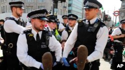 Police arrests protestors at Oxford Circus in London, Friday, April 19, 2019. The group Extinction Rebellion is calling for a week of civil disobedience against what it says is the failure to tackle the causes of climate change.