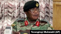 Zimbabwe's Army Commander, Constantino Chiwenga addresses a press conference in Harare, Monday, Nov. 13, 2017. The army commander Monday criticized the instability in the country’s ruling party caused by President Robert Mugabe who last week fired a vice president. (AP Photo/Tsvangirayi Mukwazhi)