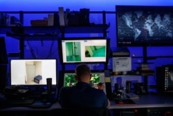 A computer forensic analyst reviews a case inside the Victim Identification Lab, part of Homeland Security's Child Exploitation Investigations Unit, in Fairfax, Va., Nov. 22, 2019. T
