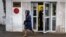 A security guard stands at the door of the building of the editorial office of Novaya Gazeta newspaper in Moscow, Russia, March 15, 2021.