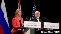 European Union foreign policy chief Federica Mogherini and Iranian Foreign Minister Mohammad Javad Zarif announce a landmark deal to curb Iran's nuclear program in exchange for relief from international sanctions in Vienna, Austria, July 14, 2015.