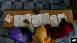 FILE - Rohingya Muslim children recite from the holy Quran at a school in Klang, on the outskirts of Kuala Lumpur, Malaysia, Sept. 12, 2017.