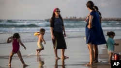 An Israeli Jewish woman wears a modest swimsuit on the beach near the port city of Ashdod, Israel, Sept. 1, 2016.