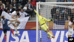 United States' Abby Wambach scores her side's second goal during the semifinal match between France and the United States at the Women's Soccer World Cup in Moenchengladbach, Germany, July 13, 2011