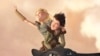 Astrid (America Ferrera) and Hiccup (Jay Baruchel) soar through the sky on the wings of Toothless