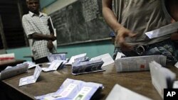 Poll workers finish counting votes at a polling station in the Treichville neighborhood of Abidjan, Ivory Coast, 28 Nov. 2010