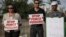 Israeli Arab supporters of Mohammed Allan, a Palestinian prisoner on a hunger strike, hold signs during a support rally, in Ashkelon Israel, Aug. 11, 2015.