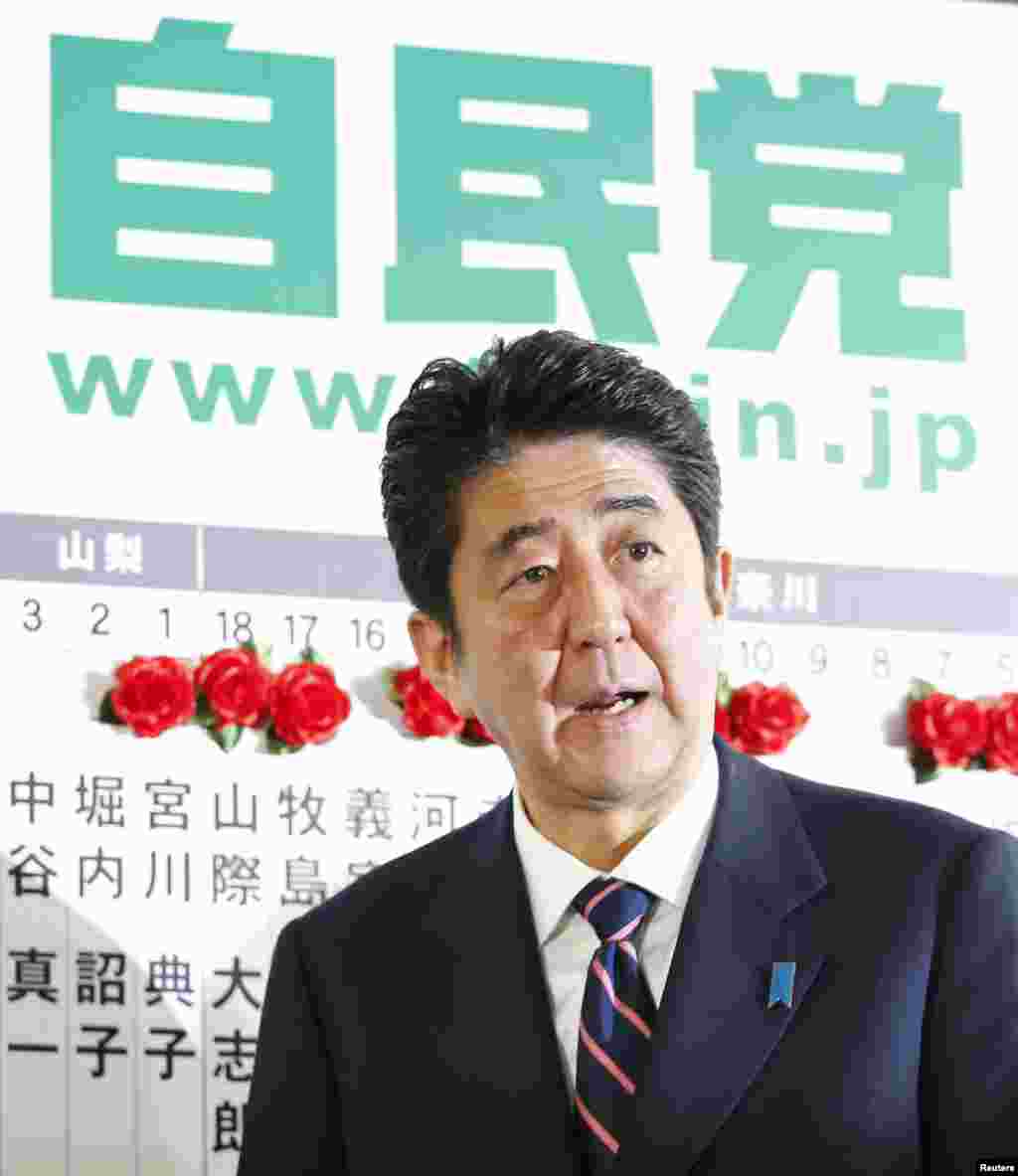 Japan's main opposition Liberal Democratic Party's (LDP) leader and former Prime Minister Shinzo Abe stands in front of a board reading LDP at the party headquarters in Tokyo December 16, 2012. LDP surged back to power in an election on Sunday just three 