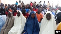 FILE - Children cleared of ties with Boko Haram wait to be released by the military in Maiduguri, July 9, 2018. 