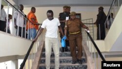 Tanzanian investigative journalist Erick Kabendera leaves after he appeared at the Kisutu residents magistrate court in Dar es Salaam, Tanzania, Sept. 12, 2019.