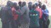 FILE: Highlanders acting chairman Modern Ngwenya pleads with second assistant referee Thomas Kusosa to return to the touchline after the match official was pelted with missiles.