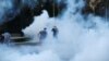 Serbia, Belgrade,Demonstrators stand among tear gas during an anti-government rally, amid the spread of the coronavirus disease