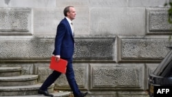 FILE - Britain's Foreign Secretary Dominic Raab leaves the Foreign and Commonwealth Office in central London, July 1, 2020. 