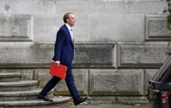 FILE - Britain's Foreign Secretary Dominic Raab leaves the Foreign and Commonwealth Office in central London, July 1, 2020.