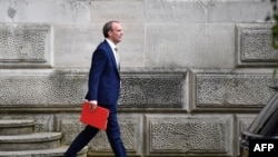 FILE - Britain's Foreign Secretary Dominic Raab leaves the Foreign and Commonwealth Office in central London, July 1, 2020. 