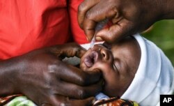 FILE - A baby receives an oral polio vaccine during the Malawi Polio Vaccination Campaign Launch in Lilongwe, Malawi, on March 20, 2022.