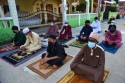 Muslim worshippers perform the morning Eid al-Fitr prayers on the street after authorities closed mosques in Thailand to prevent the spread of COVID-19 coronavirus, May 13, 2021.