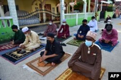 Muslim worshippers perform the morning Eid al-Fitr prayers on the street after authorities closed mosques in Thailand to prevent the spread of COVID-19 coronavirus, May 13, 2021.