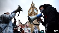 Pro-Palestinian protesters chant slogans in front of Elizabeth Tower, commonly known by the name of the clock's bell, "Big Ben," at the Palace of Westminster, home to parliament, in central London on Jan. 6, 2024. They demanded a cease-fire in the Israel-Hamas war.