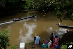 Locals commute on  the Indio River adjacent   El Jobo village, Panama, Aug. 31, 2024.