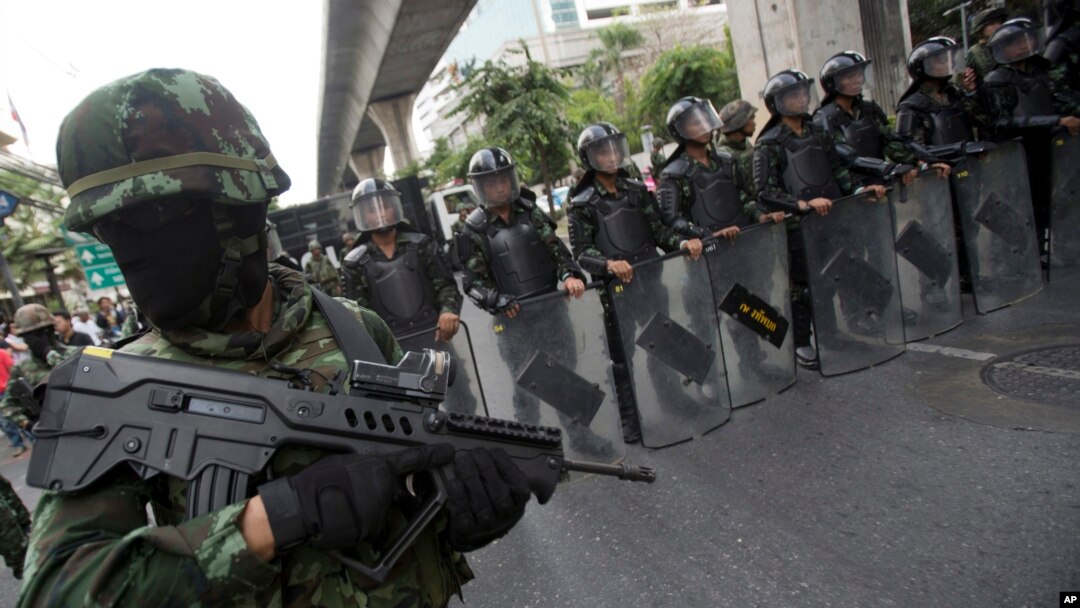 Thai soldiers guard during a protest against the coup in Bangkok, Thailand Saturday, May 24, 2014.
