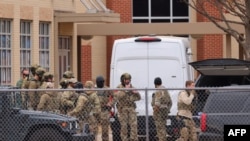 Anggota team SWAT dikerahkan menuju Sinagoge Beth Israel di Colleyville, Texas, pada 15 Januari 2022. Seorang warga negara Inggris menyandera empat orang yang berada di dalam sinagoge tersebut. (Foto: AFP/Andy Jacobson)