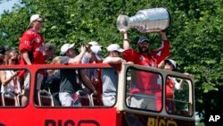 Washington Capitals NHL hockey team left wing Alex Ovechkin holds up the Stanley Cup during a victory parade, June 12, 2018, in Washington. 