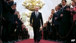  Vladimir Putin walks during his inauguration ceremony as new Russia's president in the Grand Kremlin Palace in Moscow, Russia, Monday, May 7, 2018. Putin took the oath of office for his fourth term as Russian president on Monday and promised to pursue an economic agenda that would boost living standards across the country. (Sputnik, Kremlin Pool Photo via AP)