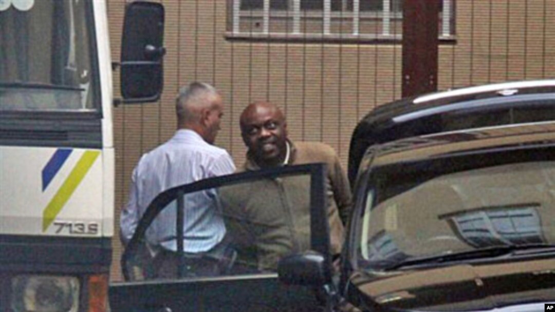 Nigerian ex-militant leader, Henry Okah (R) is led from the court in Johannesburg, 14 Oct 2010