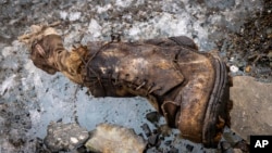 A boot and a sock are discovered on the Central Rongbuk Glacier below the North Face of Mount Everest, Oct. 11, 2024. (Jimmy Chin/National Geographic via AP)