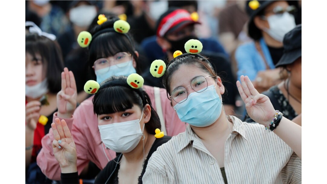 Protesters flash the three-finger protest gesture during a rally in Bangkok, Thailand, Nov. 25, 2020.