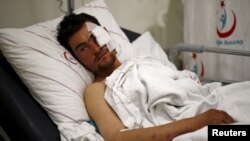 Kasim Genco, 21, a fighter with the Syrian opposition who was wounded during airstrikes on Syrian villages near the Turkey border, lies in his hospital bed in the southeastern city of Kilis, Turkey, Feb. 7, 2016. 