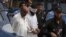 Police escort blindfolded Muslim cleric Khalid Jadoon as he is brought before a judge at a court in Islamabad, September 2, 2012.
