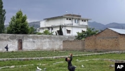 A boy plays with a tennis ball in front of Osama bin Laden's compound in Abbottabad, Pakistan, May 2011. (file photo) Osama bin Laden was killed almost a year ago, on May 2, 2011, by a United States special operations military unit in a raid on his compou