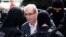 Former speaker of Brazil's Lower House of Congress, Eduardo Cunha (C), is escorted by federal police officers as he leaves the Institute of Forensic Science in Curitiba, Oct. 20, 2016. 