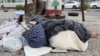 A displaced girl sleeps on the sidewalk in downtown Beirut on Oct. 1, 2024. Intense Israeli attacks have forced up to 1 million people to flee parts of Lebanon, authorities say.