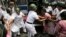 Indian policewomen detain an activist of Socialist Unity Center of India during a daylong nationwide strike in Kolkata, India, Sept. 2, 2015.