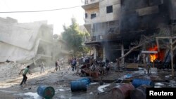 Warga berlarian setelah pesawat Suriah menjatuhkan bom di kota Aleppo, Kamis (1/5). 