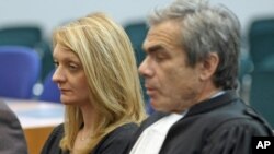 Rachel Lambert, wife of Vincent Lambert, a Frenchman who has been comatose for seven years, attends with her lawyer Laurent Petiti a verdict about her husband in the European Court of Human Rights in Strasbourg, France, June 5, 2015.