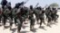 FILE - Hundreds of newly trained al-Shabab fighters perform military exercises in the Lafofe area, south of Mogadishu, Somalia.