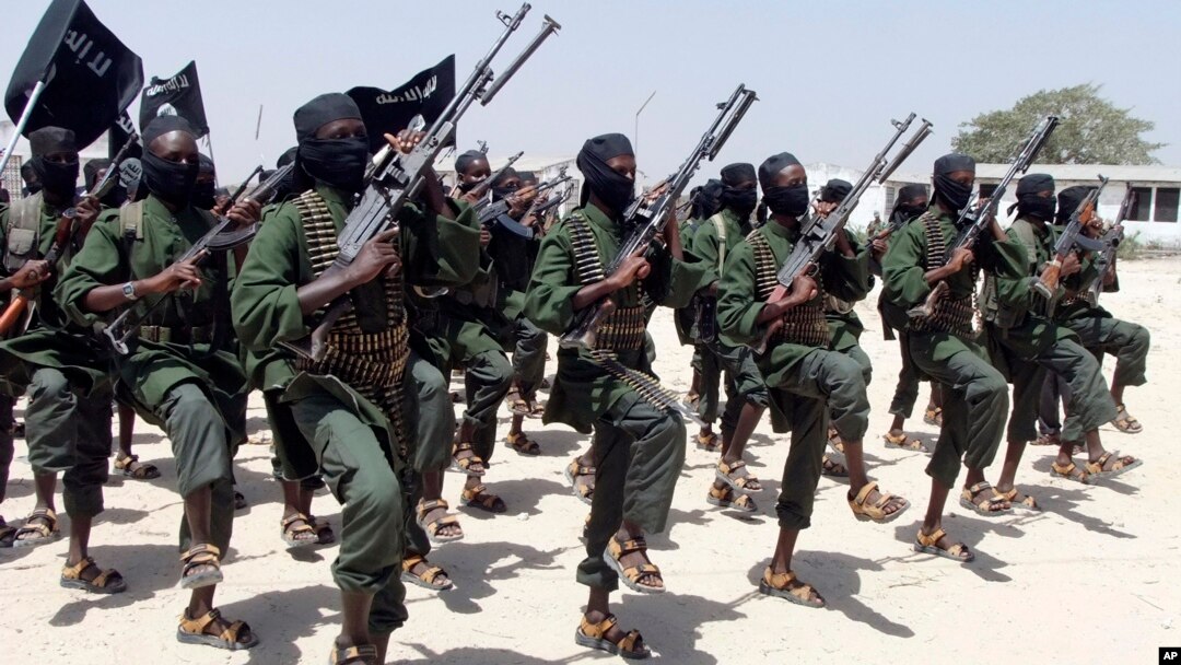 FILE - Hundreds of newly trained al-Shabab fighters perform military exercises in the Lafofe area some 18 km south of Mogadishu, in Somalia. 