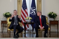 NATO Secretary General Jens Stoltenberg gestures during his meeting with President Donald Trump at Winfield House, in London, Dec. 3, 2019.