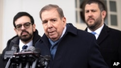 Venezuela's opposition leader Edmundo Gonzalez, center, speaks with reporters at the White House in Washington, Jan. 6, 2025.