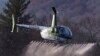 A Rotor Technologies unmanned semi-autonomous helicopter sprays a payload of water during a test flight over Intervale Airport, Monday, Nov. 11, 2024, in Henniker, N.H. (AP Photo/Charles Krupa)