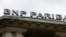 The logo of French bank BNP Paribas is seen above the facade of their central Paris agency June 30, 2014. 