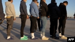 This image released by the U.S. Department of Defense shows shackled undocumented migrants preparing to board a C-17 Globemaster III at Fort Bliss, Texas, Jan. 23, 2025. (AFP/DVIDS/Department of Defense/U.S. Army Sgt. 1st Class Nicholas J. De La Pena)