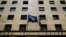 FILE - A European Union flag (L) flutters next to a Greek flag on the facade of the Bank of Greece headquarters in Athens.