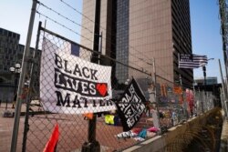 Black Lives Matter flags fly and line the fence surrounding the Hennepin County Government Center, April 2, 2021 in Minneapolis, where the trial for former Minneapolis police officer Derek Chauvin continues.