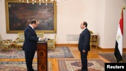 Egyptian President Abdel Fattah al-Sisi (R) listens to the swearing in of Major General Abbas Kamel, newly appointed chief of the country's General Intelligence Service at the Ittihadiya presidential palace in Cairo, Egypt, June 28, 2018.