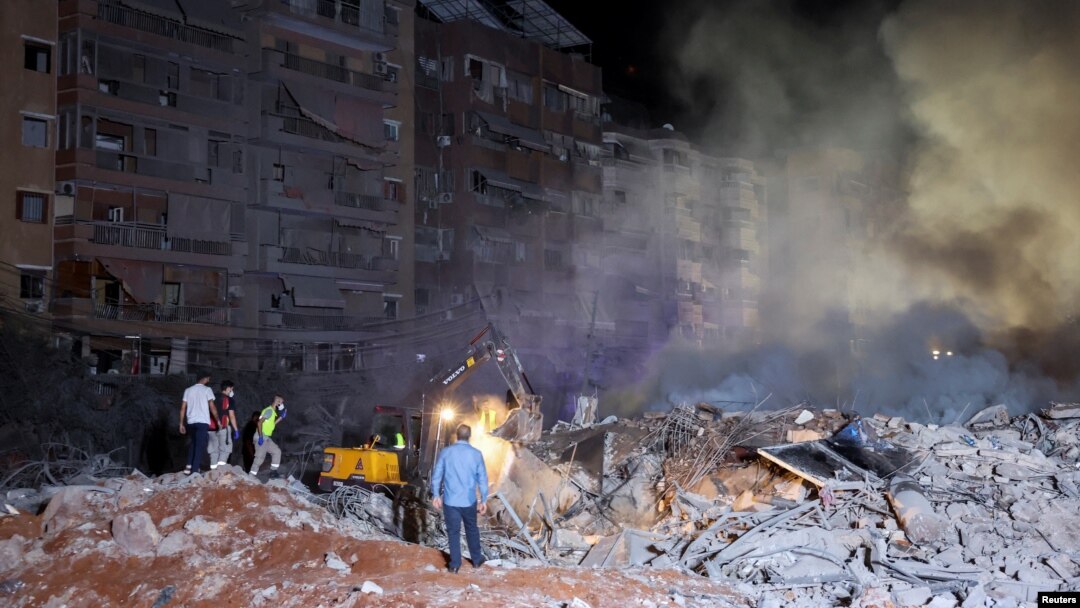 Smoke rises after explosions, in Beirut